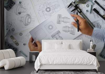 Engineer technician designing drawings mechanical parts engineering Engine.manufacturing factory Industry Industrial work project blueprints measuring bearings caliper tools Wall mural